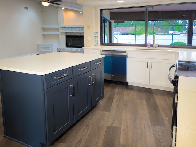 kitchen with sink, stainless steel dishwasher, ceiling fan, dark hardwood / wood-style flooring, and range