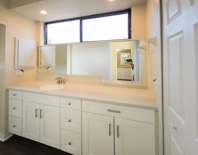 bathroom with hardwood / wood-style floors and vanity