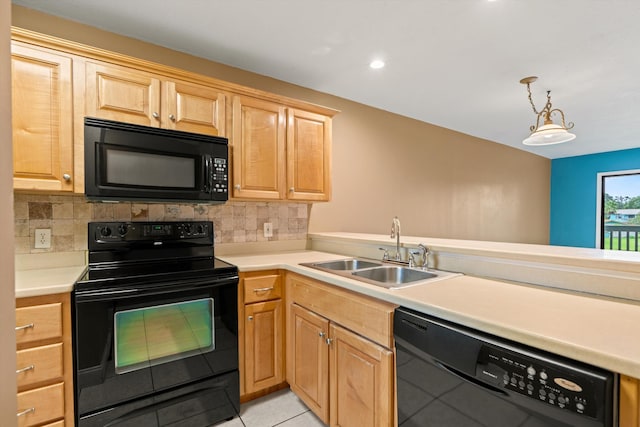 kitchen with pendant lighting, sink, backsplash, and black appliances