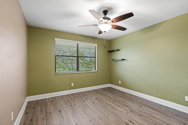 empty room with a textured ceiling, light hardwood / wood-style floors, and ceiling fan