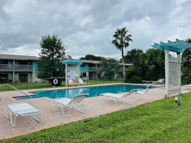 view of swimming pool featuring a pergola, a patio area, and a lawn