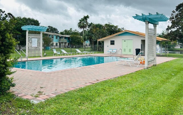 view of pool with a yard and a patio