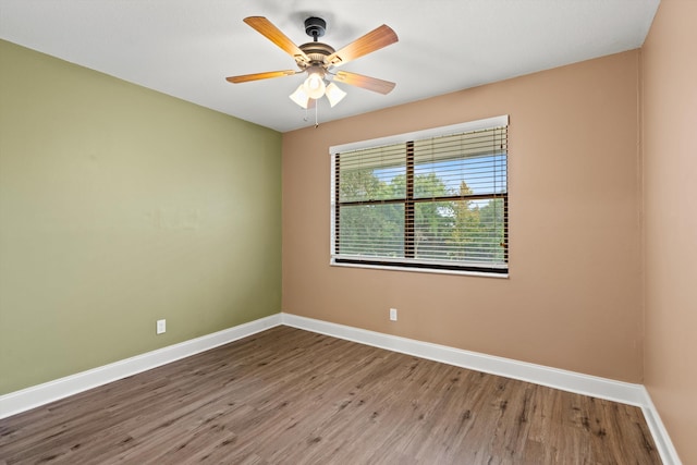 unfurnished room featuring hardwood / wood-style floors and ceiling fan