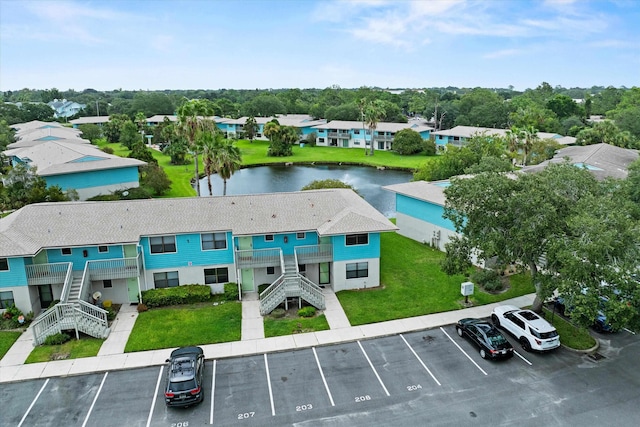 birds eye view of property with a water view