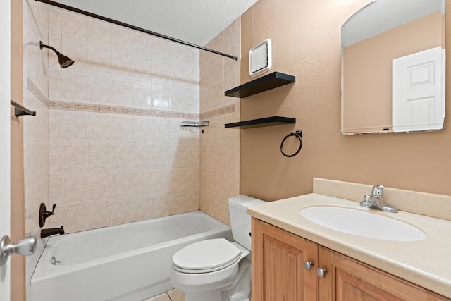 full bathroom featuring vanity, toilet, a textured ceiling, and tiled shower / bath combo