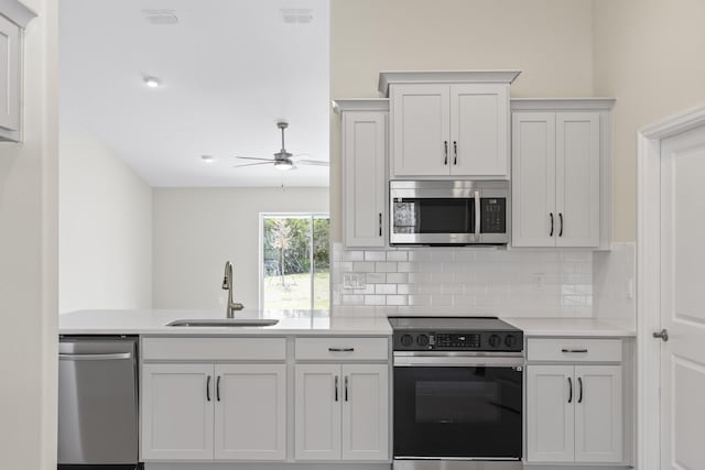 kitchen with white cabinetry, appliances with stainless steel finishes, sink, and decorative backsplash