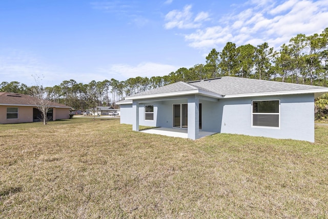 back of property featuring a yard and a patio area