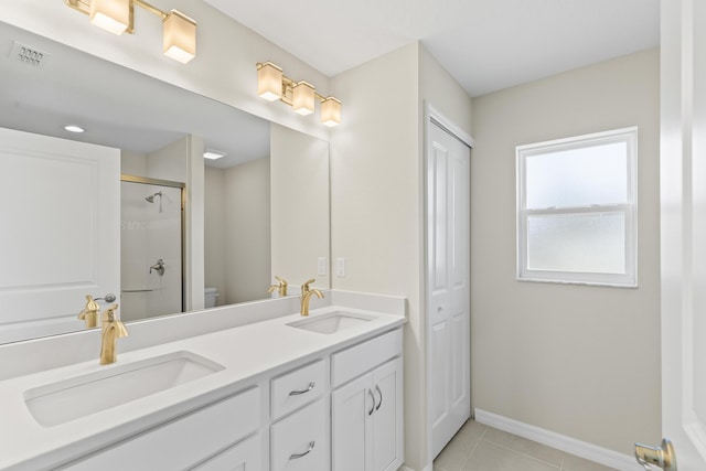 bathroom featuring walk in shower, vanity, tile patterned floors, and toilet