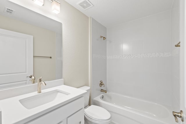 full bathroom featuring vanity, tiled shower / bath combo, and toilet