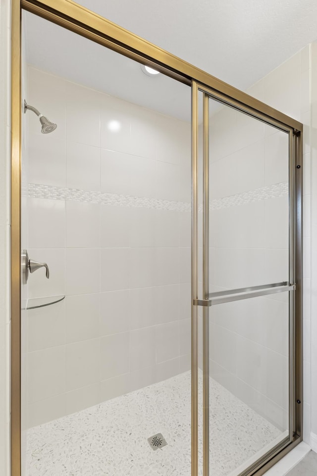 bathroom with a shower with door