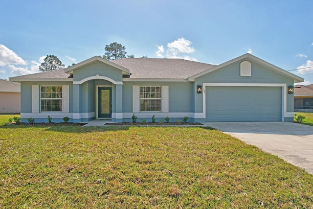 ranch-style house featuring a garage and a front lawn