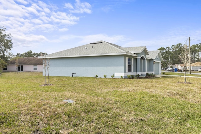 view of property exterior with a garage and a yard