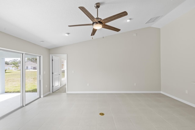 unfurnished room with light tile patterned floors, vaulted ceiling, and ceiling fan