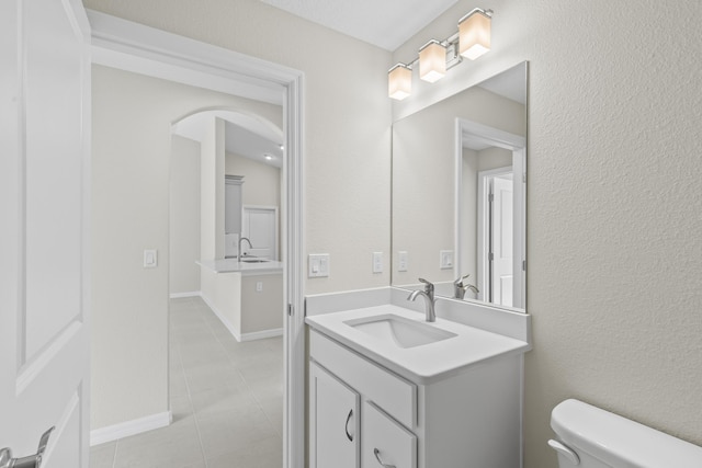 bathroom with vanity, toilet, and tile patterned flooring