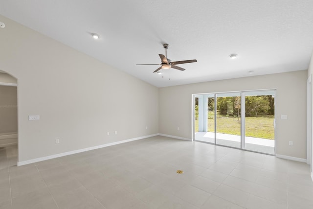 spare room with a textured ceiling, ceiling fan, and light tile patterned flooring