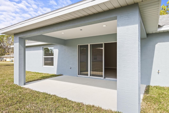 rear view of property featuring a yard and a patio area