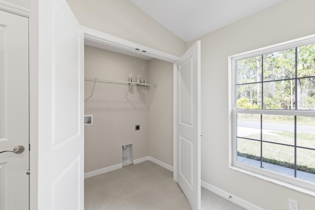 laundry room with light tile patterned floors, hookup for a washing machine, and hookup for an electric dryer