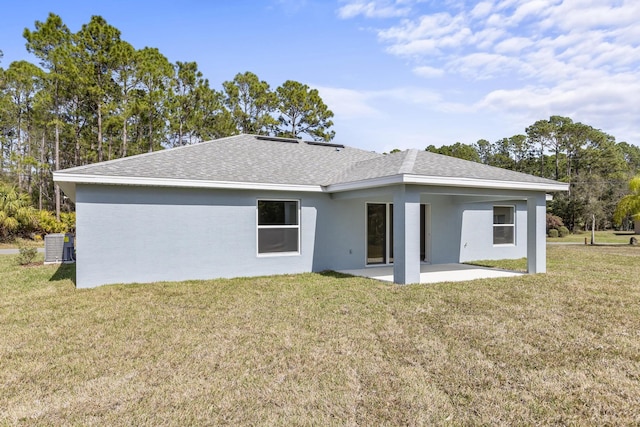 rear view of property with central AC, a lawn, and a patio