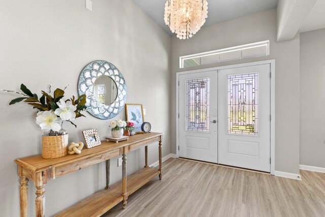 66 Magdaleno Ct, Saint Augustine, FL 32092 - foyer entrance featuring french doors, light wood finished floors, baseboards, and a chandelier