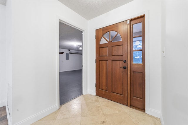 foyer entrance with a textured ceiling