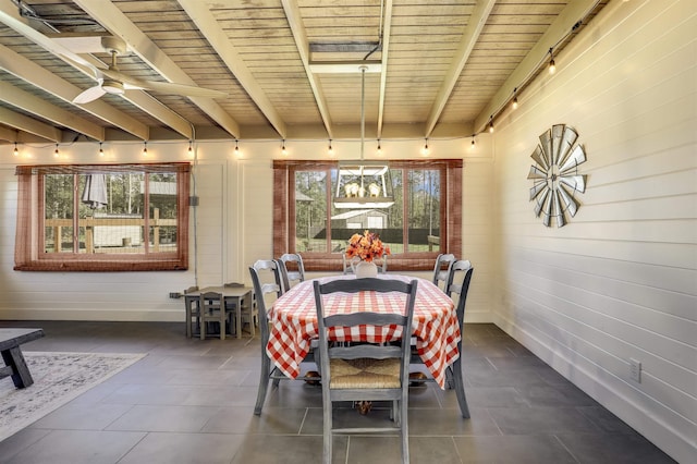 dining room featuring beamed ceiling and wood ceiling