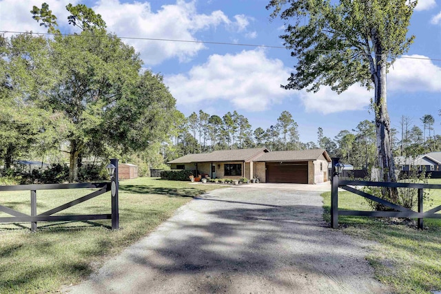 view of front of house featuring a garage and a front lawn