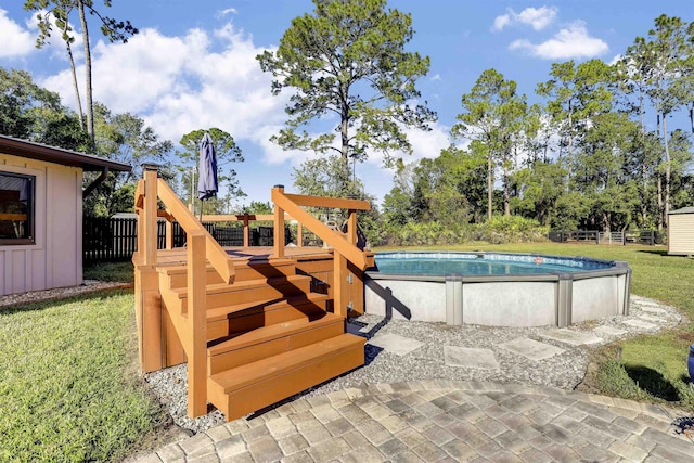 view of pool with a yard