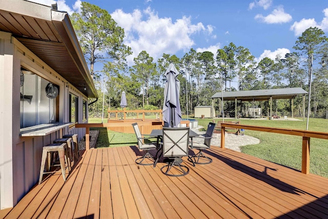 wooden terrace featuring a yard