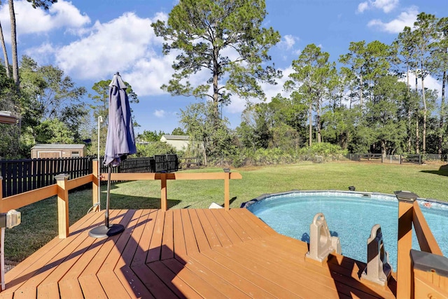 view of swimming pool featuring a yard and a wooden deck