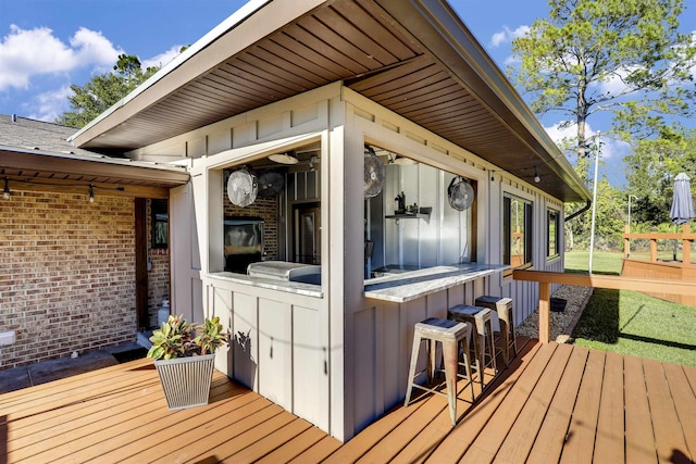 wooden deck featuring an outdoor bar