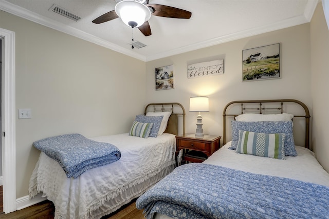 bedroom with ceiling fan, crown molding, and dark wood-type flooring