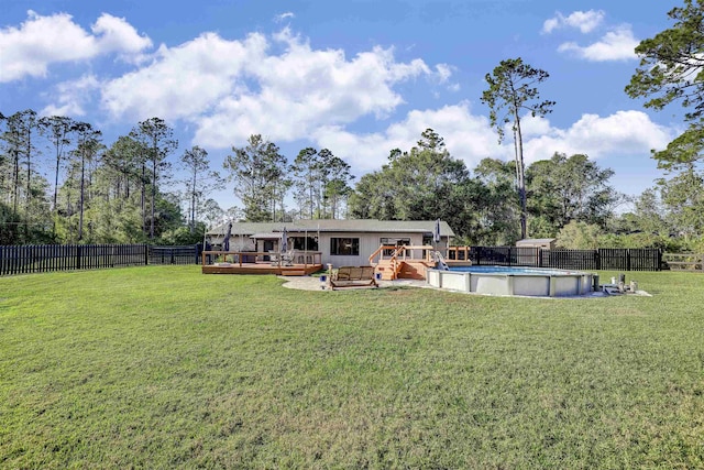 back of property featuring a swimming pool side deck and a yard