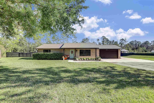 ranch-style house featuring a front yard and a garage