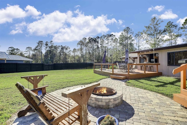 view of patio with a fire pit and a wooden deck