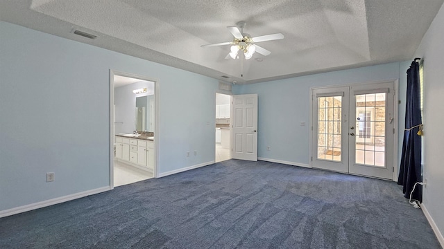 unfurnished room featuring a textured ceiling, carpet floors, french doors, a ceiling fan, and baseboards