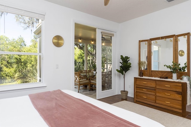 1036 Saltwater Cir, Saint Augustine, FL 32080 - bedroom featuring access to exterior, ceiling fan, and dark wood finished floors