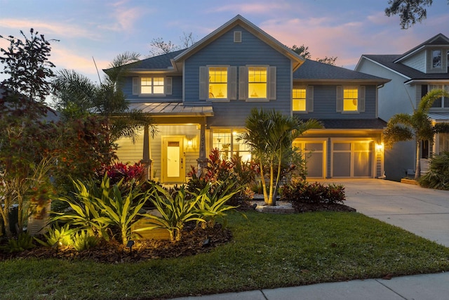 1036 Saltwater Cir, Saint Augustine, FL 32080 - view of front of property featuring concrete driveway, a garage, a standing seam roof, a front lawn, and a metal roof