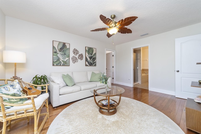 1036 Saltwater Cir, Saint Augustine, FL 32080 - living area featuring wood finished floors, a ceiling fan, and a textured ceiling