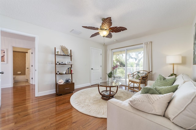 1036 Saltwater Cir, Saint Augustine, FL 32080 - living room with wood finished floors, a ceiling fan, and a textured ceiling