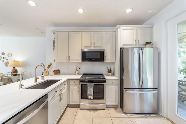 1036 Saltwater Cir, Saint Augustine, FL 32080 - kitchen with stainless steel appliances, tasteful backsplash, light tile patterned flooring, recessed lighting, and a peninsula