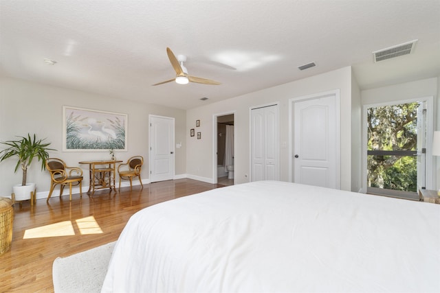 1036 Saltwater Cir, Saint Augustine, FL 32080 - bedroom with wood finished floors, multiple closets, and ceiling fan