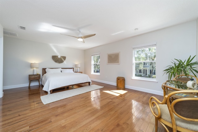 1036 Saltwater Cir, Saint Augustine, FL 32080 - bedroom featuring multiple windows, wood finished floors, and a ceiling fan