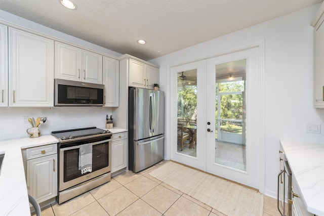 1036 Saltwater Cir, Saint Augustine, FL 32080 - kitchen featuring appliances with stainless steel finishes, french doors, decorative backsplash, light tile patterned floors, and recessed lighting