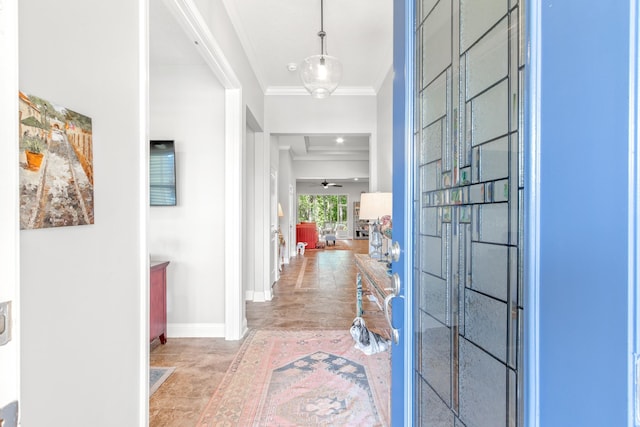 foyer with ceiling fan and ornamental molding