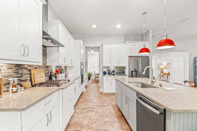 kitchen with sink, white cabinetry, stainless steel appliances, and hanging light fixtures