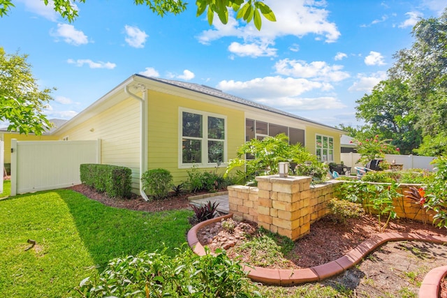 view of property exterior with a lawn