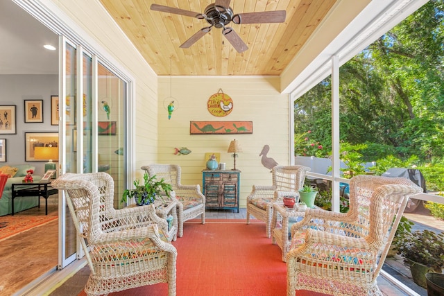 sunroom with ceiling fan and wood ceiling