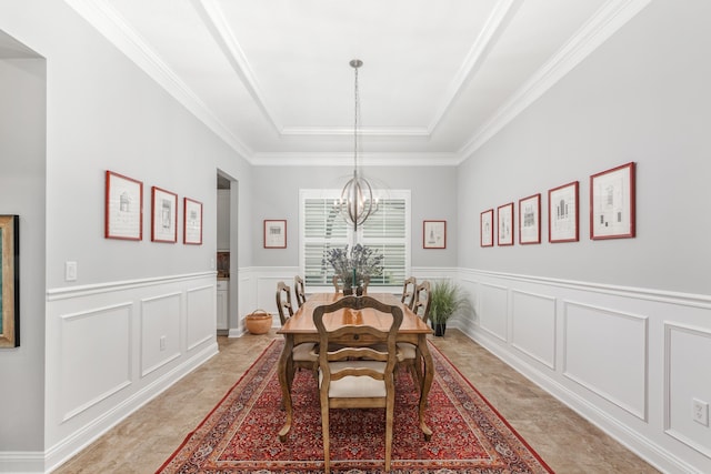 dining area with crown molding and a notable chandelier