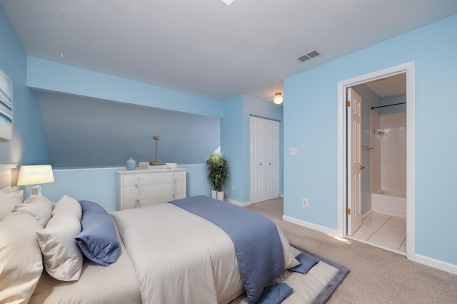 carpeted bedroom featuring connected bathroom and a closet