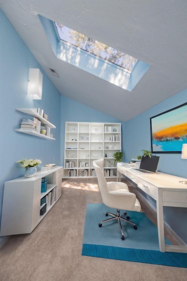 home office with carpet floors and lofted ceiling with skylight